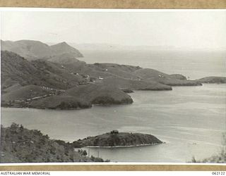 PORT MORESBY AREA, NEW GUINEA. 1943-12-29. VIEW FROM TUA-GUBA HILL LOOKING TOWARDS PYRAMID POINT. BUILDINGS IN THE CENTRE ARE THE KILA NATIVE LABOUR AND TRANSIT CAMPS