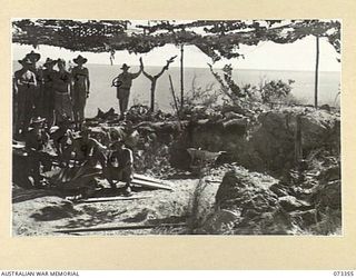 PORT MORESBY, NEW GUINEA. 1944-05-24. MEMBERS OF THE BASILISK BATTERY, 801ST ANTI-AIRCRAFT AND COAST ARTILLERY BATTERY, HEADQUARTERS MORESBY BASE SUB-AREA BESIDE EXCAVATIONS AT THE BATTERY ..