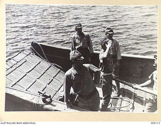 AT SEA, OFF BUIN, BOUGAINVILLE, 1945-08-20. A JAPANESE SALUTING AFTER RECEIVING MESSAGE AND INSTRUCTIONS TO RETURN TO LIEUTENANT-GENERAL M. KANDA, COMMANDER IMPERIAL JAPANESE 17 ARMY GROUP. THE ..