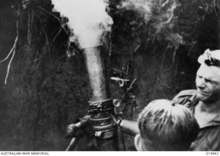 1943-09-28. NEW GUINEA. ADVANCE ON SALAMAUA. AN AUSTRALIAN THREE INCH MORTAR IN ACTION AGAINST THE JAPANESE ON BOBDUBI RIDGE, SALAMAUA. (NEGATIVE BY PARER NEWSREEL)