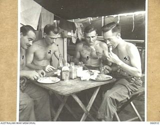 LAE, NEW GUINEA. 1944-06-14/02. MEMBERS OF THE 12TH WATER TRANSPORT OPERATING COMPANY, ENJOYING A MEAL ON THE DECK OF ONE OF THEIR SHIPS. IDENTIFIED PERSONNEL ARE:- LANCE CORPORAL H. ALBERTSEN (1); ..