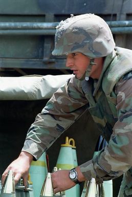 A marine from Bravo Battery, 1ST Battalion, 12th Marines, 3rd Marine Regiment prepares 155 milimeter rounds to a M198 155mm Medium Towed Howitzer during a combined arms live fire exercise. The M198 is constructed of aluminum and steel, and is air transportable by CH-53E helicopter and C-130 or larger fixed-wing aircraft. Maximum effective range with conventional ammunition is 22,400 meters (13.92 miles) and with a rocket-assisted projectile, 30,000 meters (18.64 miles)
