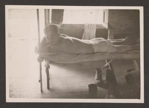 [Man Resting on Cot]