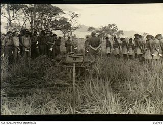 DUMPU, NEW GUINEA, 1943-10-10. TROOPS OF HEADQUARTERS, 21ST AUSTRALIAN INFANTRY BRIGADE AND THE PAPUAN INFANTRY BATTALION, ATTENDING A CHURCH PARADE IN THE RAMU VALLEY. SHOWN ARE:- NX34661 CAPTAIN ..