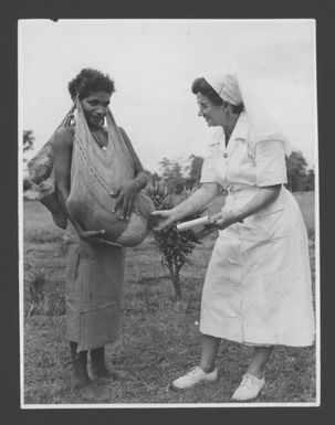 [Nursing sister attending a mother with her twin babies in bilums from the Ioma region, Oro Province, Papua New Guinea] Australian News and Information Bureau