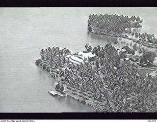 ALEXISHAFEN, NEW GUINEA. AERIAL VIEW OF THE MISSION AND CATHEDRAL WHICH WERE COMPLETELY DESTROYED IN THE COURSE OF THE WAR. (NAVAL HISTORICAL COLLECTION)