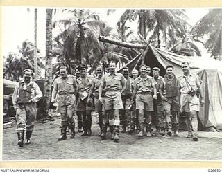 MILNE BAY, PAPUA. 1942-09. GROUP OF FIGHTER PILOTS, MAINLY OF NO. 76 SQUADRON RAAF. SECOND FROM THE LEFT IS SQUADRON LEADER K.W. TRUSCOTT, COMMANDING OFFICER OF 76 FIGHTER SQUADRON