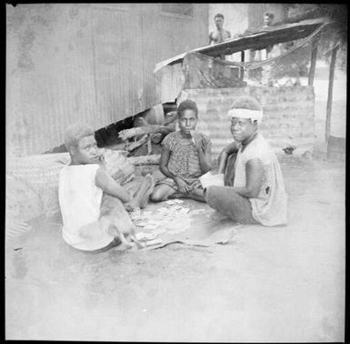 Three women playing cards, New Guinea, ca. 1936 / Sarah Chinnery