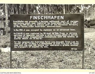 FINSCHHAFEN AREA, NEW GUINEA, 1944-03-20. ONE OF MANY BATTLE SIGNS IN THE FINSCHHAFEN AREA, THIS SIGN RECORDS THE ACTIVITIES OF THE 20TH INFANTRY BRIGADE, AND NOTES THE ASSISTANCE RECEIVED FROM THE ..
