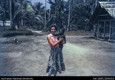 European woman holding  Papua New Guinean child