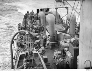 AT SEA, 1944-08-20. TROOPS OF THE 25TH INFANTRY BATTALION ON THE DECK OF THE RAN FRIGATE, HMAS "BARCOO" WHILE ON THE JOURNEY FROM SIAR TO POTSDAM