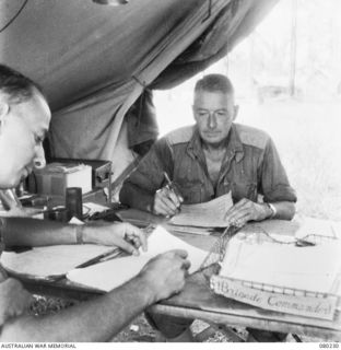 ALEXISHAFEN, NEW GUINEA. 1944-07. NX110380 BRIGADIER C.E. CAMERON, MC, ED, (1), DICTATING INSTRUCTIONS AT HEADQUARTERS 8TH INFANTRY BRIGADE