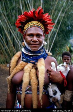 Woman in ceremonial dress holding cat