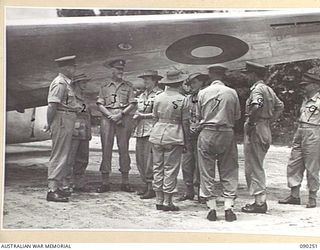 TOROKINA, BOUGAINVILLE. 1945-03-30. LADY WAKEHURST (4), AND LADY BLAMEY (6), TALKING WITH COLONEL D. DWYER, MATRON HURLEY, 2/1 GENERAL HOSPITAL, AND OTHER OFFICERS UNDERNEATH THE WING OF THE ..