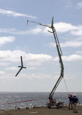 An unmanned aerial vehicle (UAV) called the"Scan Eagle"is recovered after a flight onboard the U.S. Navy Tarawa Class Amphibious Assault Ship USS SAIPAN (LHA 2) during operations in the Atlantic Ocean on Aug. 18, 2006. The"Scan Eagle"is designed to provide persistent intelligence, surveillance and reconnaissance data, battle damage assessment and communications relay in support of the Global War On Terrorism. (U.S. Navy photo by Mass Communication SPECIALIST SEAMAN Patrick W. Mullen III) (Released)