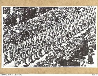 MELBOURNE, AUS. 1943-11-18. TROOPS OF THE 17TH AUSTRALIAN INFANTRY BRIGADE MARCHING ALONG SWANSTON STREET UPON ITS RETURN TO THE MAINLAND AFTER A LONG TERM OF ACTIVE SERVICE IN NEW GUINEA