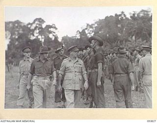 TOROKINA, BOUGAINVILLE, 1945-07-11. LIEUTENANT-GENERAL S.G. SAVIGE, GENERAL OFFICER COMMANDING 2 CORPS (1), ACCOMPANIED BY SENIOR OFFICERS, INSPECTING HEADQUARTERS COMPANY, 26 INFANTRY BATTALION, ..