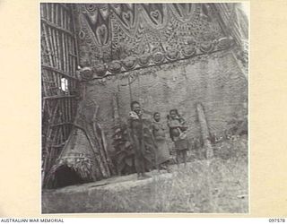MAPRIK, NEW GUINEA. 1945-10-03. GENERAL SHOT SHOWING "HOUSE TAMBORAN"; THIS IS THE NATIVE'S SACRED HOUSE OF KNOWLEDGE. YOUNG MEN ARE INITIATED IN THESE HOUSES