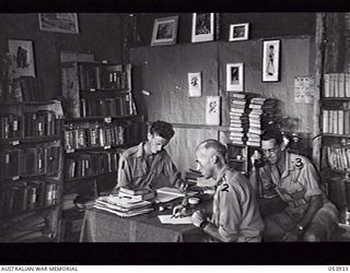 KOITAKI, NEW GUINEA. 1943-07-13. SECTION OF THE LIBRARY AT THE AUSTRALIAN ARMY EDUCATION SERVICE CENTRE, 113TH AUSTRALIAN CONVALESCENT DEPOT, AIF, AT THORPVILLE. LEFT TO RIGHT: VX118216 PRIVATE W. ..