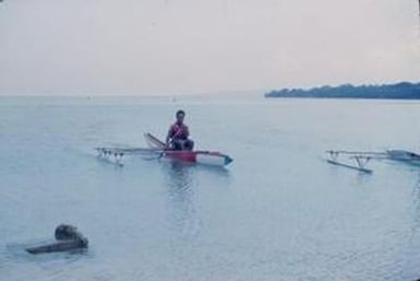 [Man in an outrigger canoe in Port Vila, Vanuatu]