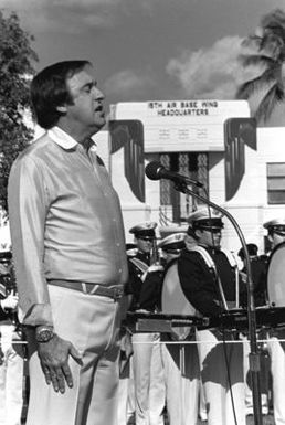 Jim Nabors sings the national anthem at the beginning of a ceremony marking the transfer of the U.S. flag flown over Hickam during the 1941 Japanese attack from the Air Force Academy Museum back to the base