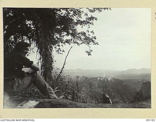 NUMA NUMA TRAIL, BOUGAINVILLE. 1945-04-24. A GENERAL VIEW LOOKING TOWARDS BERRY'S HILL WHERE ENEMY POSITIONS ARE BEING SHELLED BY AUSTRALIAN 25 POUNDERS. THIS WAS THE FIRST ACTION OF 27 INFANTRY ..