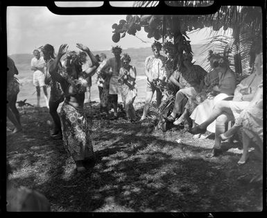 Unidentified local woman, possibly Augustine, performing the hula at a ceremony feast, Tahiti