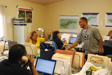 Earthquake ^ Tsunami - Ottoville, American Samoa, November 30, 2009 -- Former Philadelphia Eagles football player, Reno Mahe, expresses his appreciation to Serina Misitana, (in yellow shirt) a Federal Emergency Management Agency employee in American Samoa. Mahe, recently visited the island to observe the tsunami damage and to thank the workers assisting with disaster recovery. FEMA/Casey Deshong