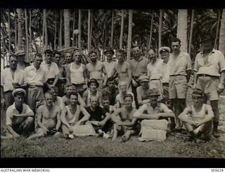 EMIRAU ISLAND. GROUP PORTRAIT OF SOME OF THE PASSENGERS AND CREW WHO HAD BEEN CAST AWAY ON EMIRAU ISLAND IN THE BISMARCK ARCHIPELAGO AFTER THEIR MERCHANT SHIPS WERE SUNK BY GERMAN RAIDERS KOMET AND ..