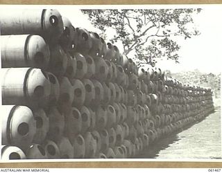 PORT MORESBY, NEW GUINEA. 1943-12-06. STACK OF JUNGLE TYPE CONTAINERS, USED FOR PARACHUTING SUPPLIES TO TROOPS IN THE FORWARD AREAS, AT NO. 2 SUB DEPOT, 10TH AUSTRALIAN ADVANCED ORDNANCE DEPOT. ..