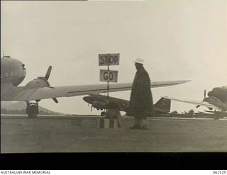 Port Moresby, New Guinea. 1944-01-06. Douglas C37 Dakota transport aircraft at Wards Airfield waiting to be loaded with personnel of the 57/60th Australian Infantry Battalion. Note the traffic ..