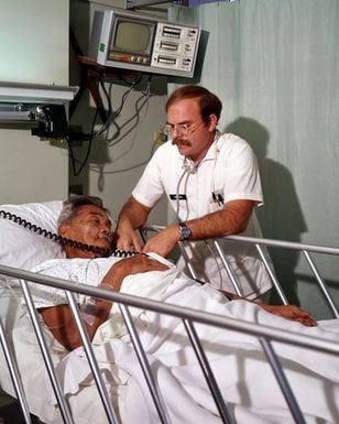 Rebecca Richardson, a physical therapist, helps a patient with therapy exercises at Tripler Army Medical Center