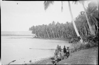 Group of six people at water's edge, New Guinea, ca. 1929 / Sarah Chinnery