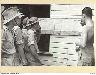 1942-12-01. NEW GUINEA. TROOPS ARE KEENLY INTERESTED IN THE NEW NEWSPAPER "GUINEA GOLD. PRODUCED UNDER DIFFICULT CONDITIONS, THE PAPER IS DISTRIBUTED FREE TO BOTH AUSTRALIAN AND AMERICAN TROOPS. ..