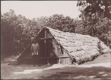 Ni-Vanuatu man standing in front of gamal in Nerinignam, Mota Lava, Banks Islands, 1906 / J.W. Beattie