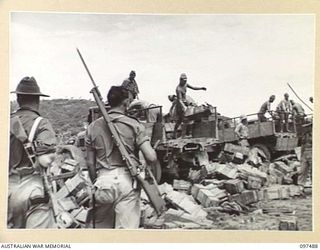 BLANCHE BAY, RABAUL, NEW BRITAIN. 1945-10-03. JAPANESE TROOPS UNLOADING 150MM SHELLS FROM TRUCKS AT THE BARGE POINT. THE SHELLS WILL BE TRANSPORTED TO SEA FOR DUMPING UNDER 28 INFANTRY BATTALION ..