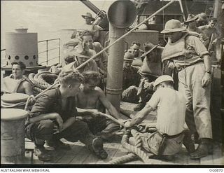 AT SEA BETWEEN GOODENOUGH ISLAND AND THE TROBRIAND ISLANDS, PAPUA. 1943-11-27. DURING THE MOVE OF NOS. 22 AND 30 SQUADRONS RAAF FROM GOODENOUGH TO KIRIWINA ON BOARD SS HANYANG A GROUP OF AIRMEN ..