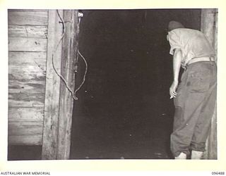 RABAUL, NEW BRITAIN, 1945-09-12. A JAPANESE TUNNEL BEING EXAMINED BY A MEMBER OF THE AUSTRALIAN FORCE DRAWN FROM 4 INFANTRY BRIGADE WHICH OCCUPIED THE FORMER ENEMY BASE AFTER THE JAPANESE ..