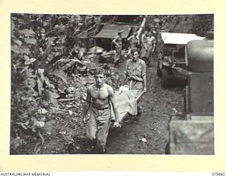 WAITAVALO AREA, WIDE BAY, NEW BRITAIN. 1945-03-16. STRETCHER CASES FROM THE 14/32ND INFANTRY BATTALION BEING TRANSPORTED TO LCM'S (LANDING CRAFT MECHANIZED) AT THE BEACHHEAD AFTER RECEIVING ..