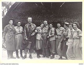 PALMALMAL, NEW BRITAIN. 1945-08-17. MR M. BANKS (5), LOOKS HAPPY WITH A GROUP OF AUSTRALIAN ARMY MEDICAL WOMEN'S SERVICE OF 2/8 GENERAL HOSPITAL WHO WERE WAITING TO GO ON DUTY WHEN THE OFFICIAL ..
