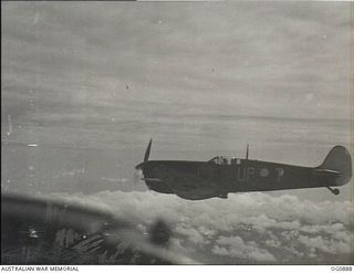 BISMARCK ARCHIPELAGO. 1944-03-28. AN AIRCRAFT, CODE NAMED UP-T, OF NO. 79 (SPITFIRE) SQUADRON RAAF, IN FLIGHT OVER NEW BRITAIN ENROUTE FROM KIRIWINA TO THE ADMIRALTY ISLANDS. PHOTOGRAPH TAKEN FROM ..