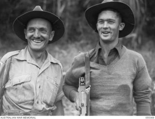 GOODVIEW, NEW GUINEA, 1943-08-03. V504081 WARRANT OFFICER 2 E. BRITTEN (LEFT) AND NX58763 CORPORAL L. BARKER, BOTH OF THE AUSTRALIAN AND NEW GUINEA ADMINISTRATIVE UNIT ATTACHED TO THE 17TH INFANTRY ..