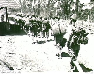 THE SOLOMON ISLANDS, 1945-09-19. A SMALL GROUP OF NONDESCRIPT JAPANESE SERVICEMEN FROM NAURU ISLAND ARRIVE BEHIND ALLIED TRUCKS AT AN INTERNMENT CAMP ON BOUGAINVILLE ISLAND. (RNZAF OFFICIAL ..