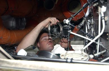 Royal Australian Air Force (RAAF) Corporal (CPL) Paul Edwin, 10th Squadron, RAAF Edinburgh, South Australia, checks the lines in the wheel well of a RAAF AP-3C Orion aircraft as it sits on the flightline at Andersen Air Force Base (AFB), Guam. The aircraft and crew are on station to participate in the joint exercise TANDEM THRUST 03, a joint US, Canada, and Australia exercise conducted in the Marianas islands to include Guam and Tinian