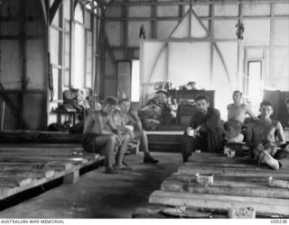 HOPOI, NEW GUINEA, 1943-10-20. TROOPS OF THE 22ND AUSTRALIAN INFANTRY BRIGADE RESTING INSIDE THE BUKAUA LUTHERAN MISSION CHURCH. THIS BUILDING WAS USED AS A HOSPITAL BY THE JAPANESE BEFORE THE FALL ..