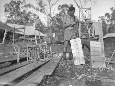 S P O'Conner of the 2nd NZEF IP making camp furniture at the works construction unit, New Caledonia