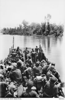 JABA RIVER AREA, BOUGAINVILLE, SOLOMON ISLANDS. 1944-12-18. 15 INFANTRY BATTALION SUPPORT TROOPS MOVING UP THE JABA RIVER BY BARGE TO ASSIST D COMPANY CONSOLIDATE ITS NEW POSITION SOUTH OF THE ..