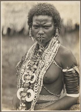 Ambasi types [a woman with lots of necklaces, standing] Frank Hurley