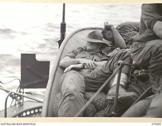 AT SEA. 1944-08-20. Q22622 LANCE CORPORAL L.W. ASHMORE, 25TH INFANTRY BATTALION (1) SOUND ASLEEP AS HE RELAXES ABOARD THE RAN FRIGATE HMAS "BARCOO" WHICH IS TRANSPORTING THE BATTALION FROM SIAR TO ..