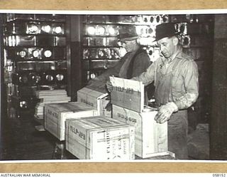 KENSINGTON, VIC. 1943-10-23. WORKMEN PACKING TINS OF FLOUR INTO BOXES AT THE MILLS OF MESSRS KIMPTON & SONS FOR DESPATCH TO THE TROOPS IN NEW GUINEA. EACH CASE CONTAINS TWO TINS, GROSS WEIGHT 66LBS